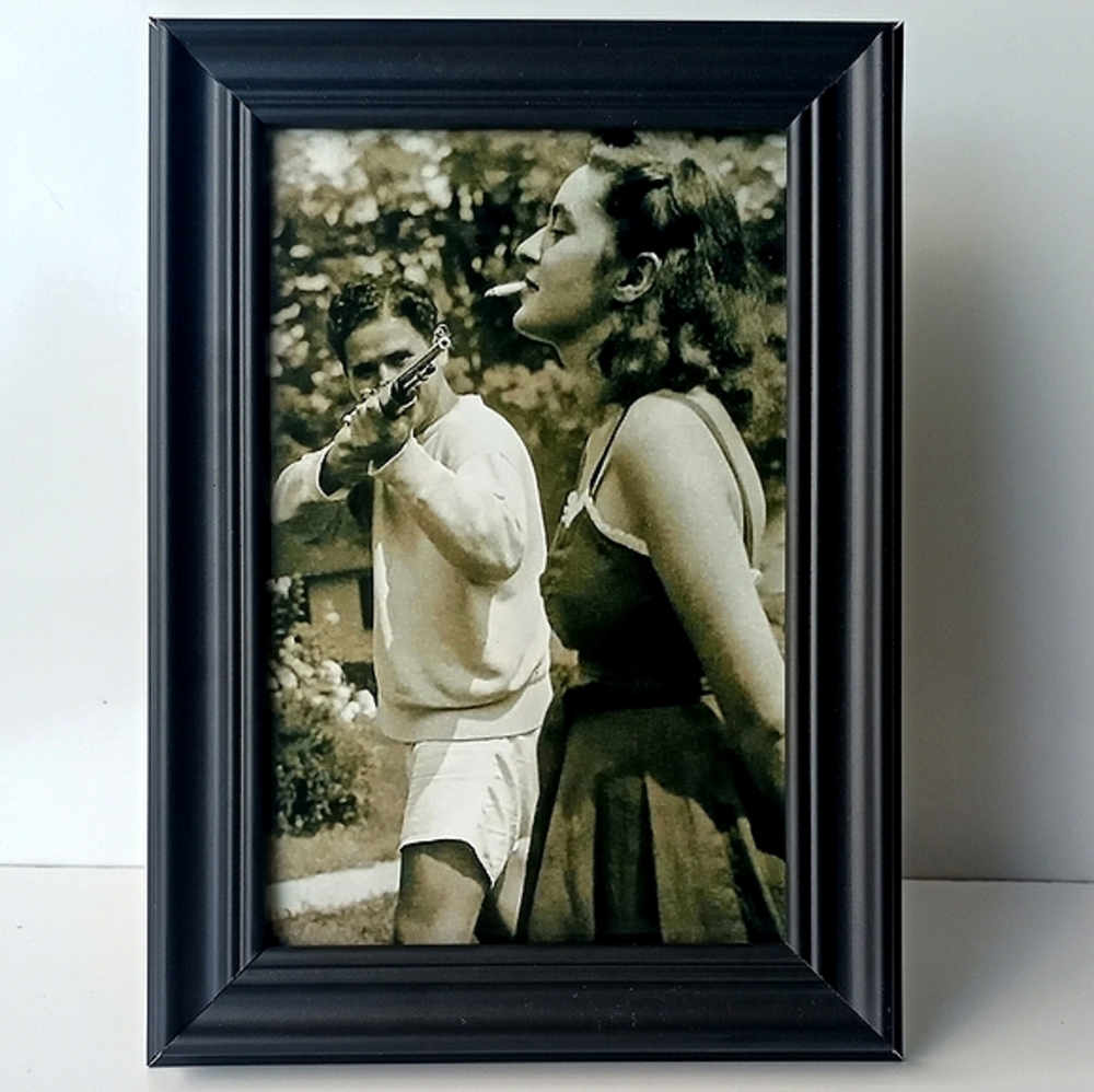 Historical photo vintage of man and woman manshooting cigarette Framed photo